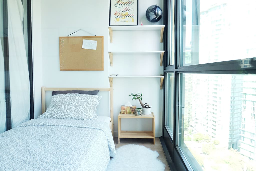 Your very small but functional bedroom. There are curtains for the windows if you prefer some shade. There are some clothes hangers on the wall opposite the bed.
