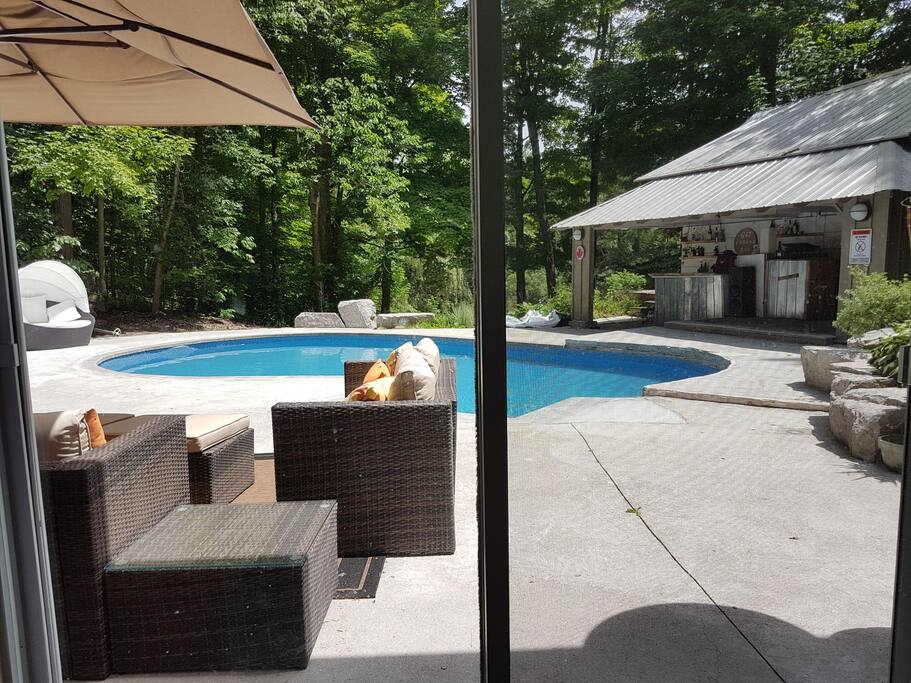 View out of the Master Bedroom across the pool and deck.