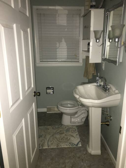 Half bath located right outside of the kitchen and garage entry way.