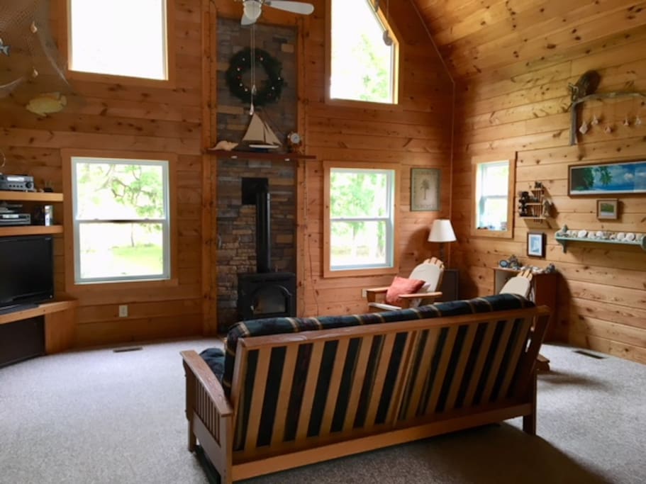 The living room with futon and two comfy chairs.