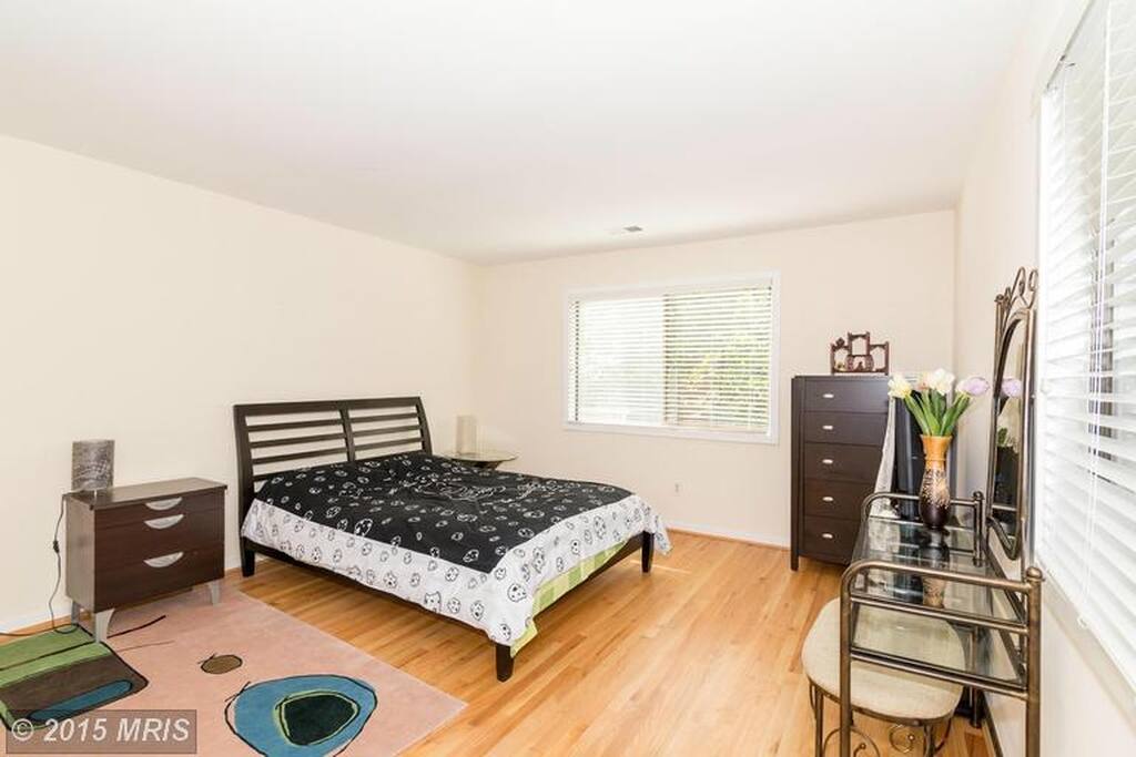 A spacious bedroom with great sun light