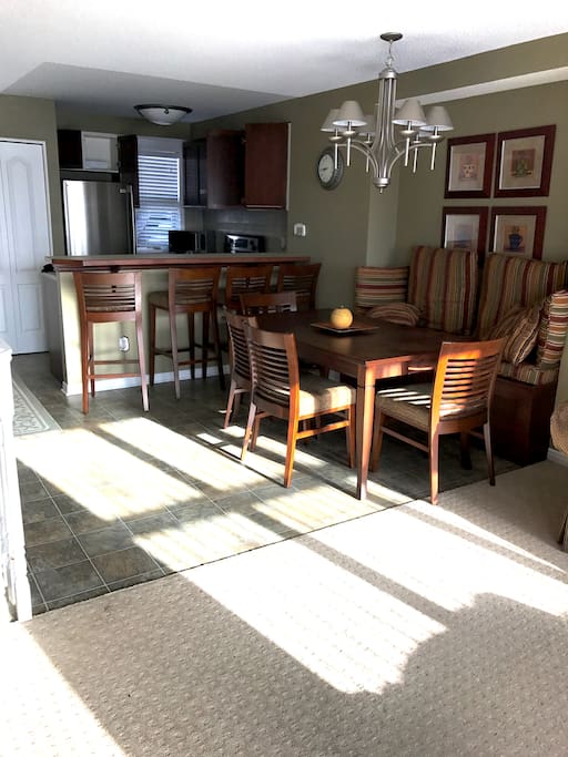 Family friendly dining area next to modern, fully equipped kitchen.