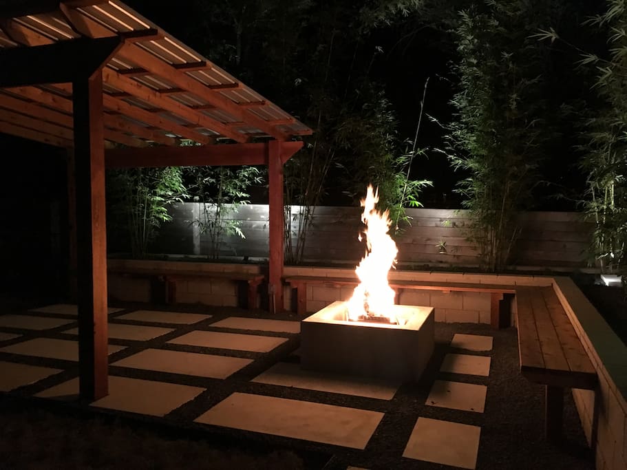 Poured concrete wood burning firepit and built in cedar benches.