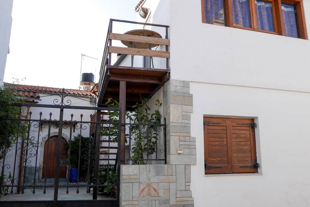 The entrance of the house. Big yard in the front. To the right where is the small window is the kitchen. Over the kitchen is the 3rd bedroom. It has autonomous entrance, through the stairs.