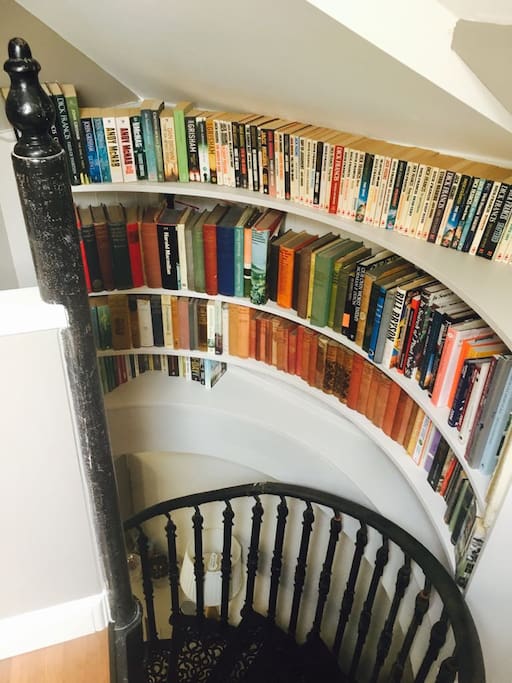 The bookcase at the top of the spiral stairs