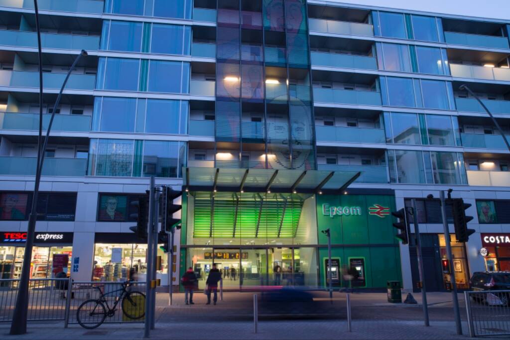 Epsom station directly opposite the flat with Tesco and Costa Coffee