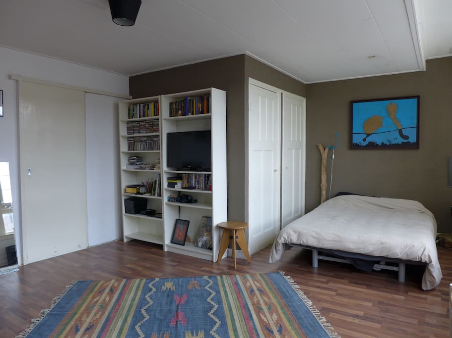 view of the bed corner from the couch door closed