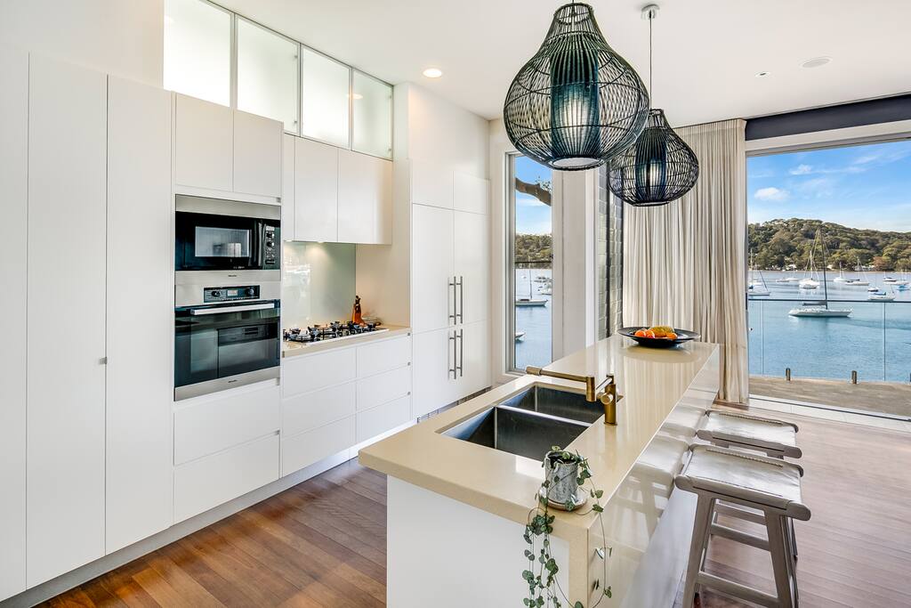 Contemporary gas kitchen with Caesarstone bench tops, integrated Miele appliances & an eat-in island.