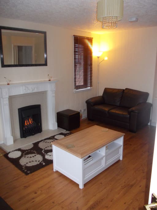 Large spacious living room with living flame gas fire. 3 Sofas.