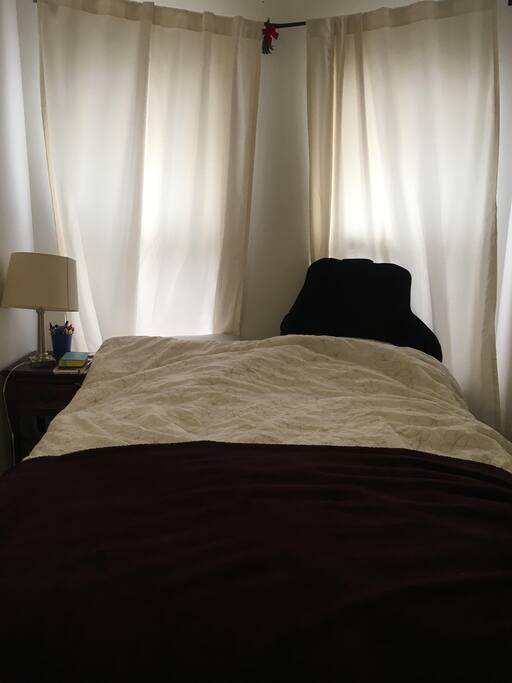 The room comes with a comfortable queen bed, and offers ample natural light, but shades and curtains allow for a good night's sleep.