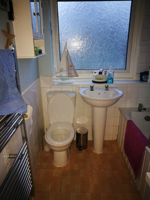 Spacious clean shared bathroom with bath and power shower