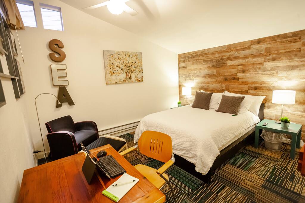 Another angle of the main part of the studio. This view also shows the reading / relaxing area that features a club chair, ottoman and reading light.