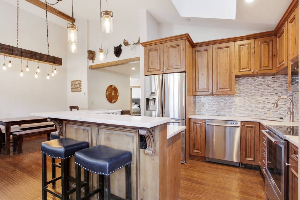 Kitchen has new appliances, backsplash and quartz counters