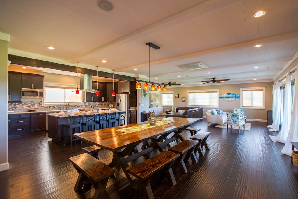 Dining room view with the large family dinner table. Living/sitting room in back