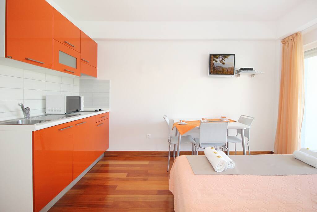 View of the kitchen and the dining table with chairs