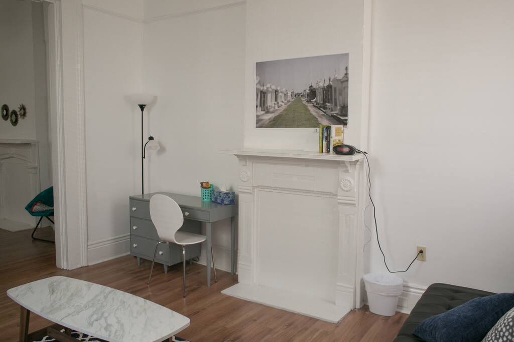 The first living room has a desk and two futons.