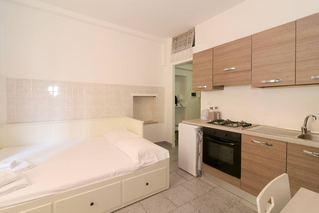 Living room with bed & equipped kitchen