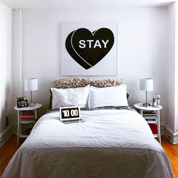 Cozy bedroom off the main entrance, featuring iconic Philadelphia local artist. Courtyard view to the right.