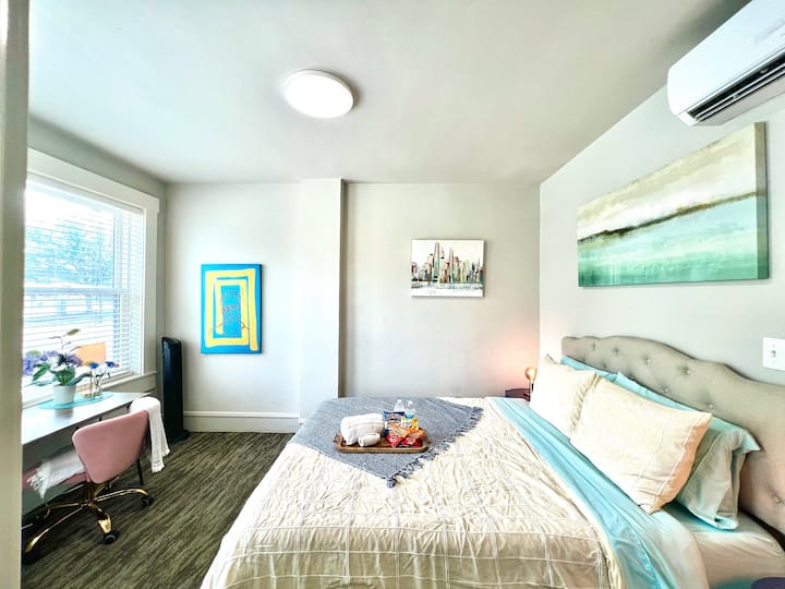 Your queen size bedroom has its own small workspace, a tower fan, and its own climate control unit.