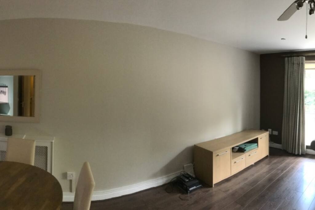 Lounge with access to private balcony (2 in total), dining table and chairs and fully fitted kitchen.