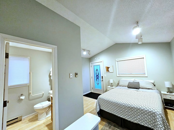 Queen bed, 3/4 private bathroom, primary entrance into home in the winter with stairs leading to lower level which is the main living area
