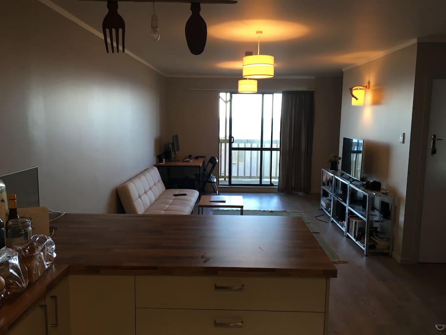 2nd Floor: View from kitchen to living room. There's a balcony accessible through the living room.