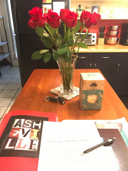 Fresh flowers and red book of Asheville recommendations and local information.