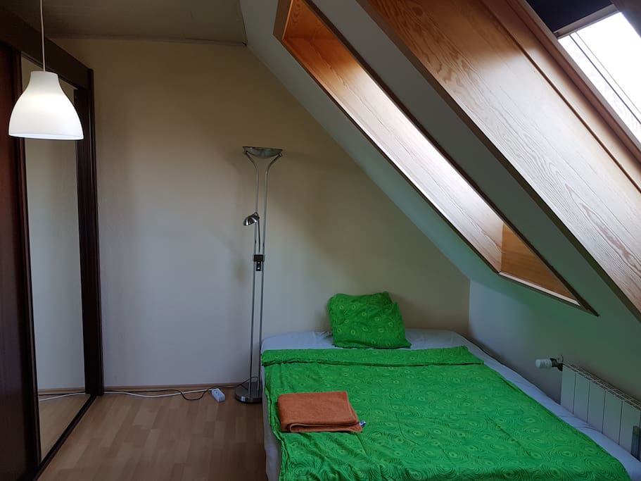 Bedroom with a bed, closet and work desk