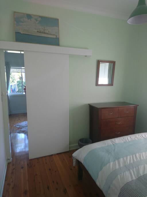 Chest of drawers & Mirror at the end of the bed .