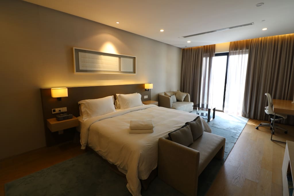 A spacious area for you to relax and unwind while enjoying the city view. There is also a study table provided for work