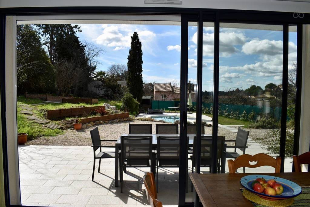 Looking from the main room to the terrace, garden and pool