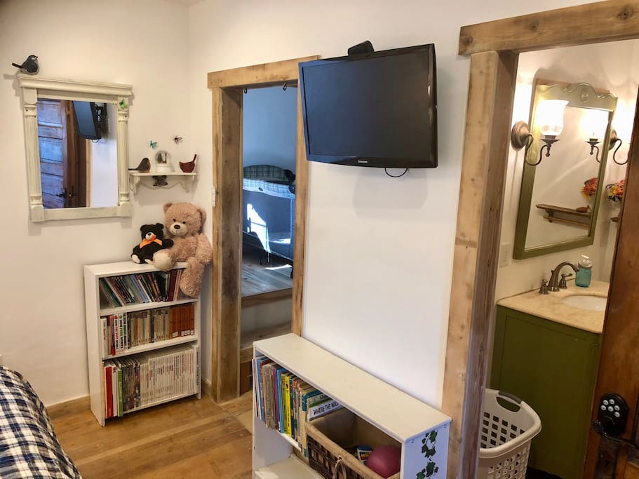 The master bedroom has its own flat panel TV with attached Apple TV and Netflix account. There are some children's books on the shelves. and you can see the pack-and-play crib in the upper section of the closet.
You'll also love having your own private bathroom.