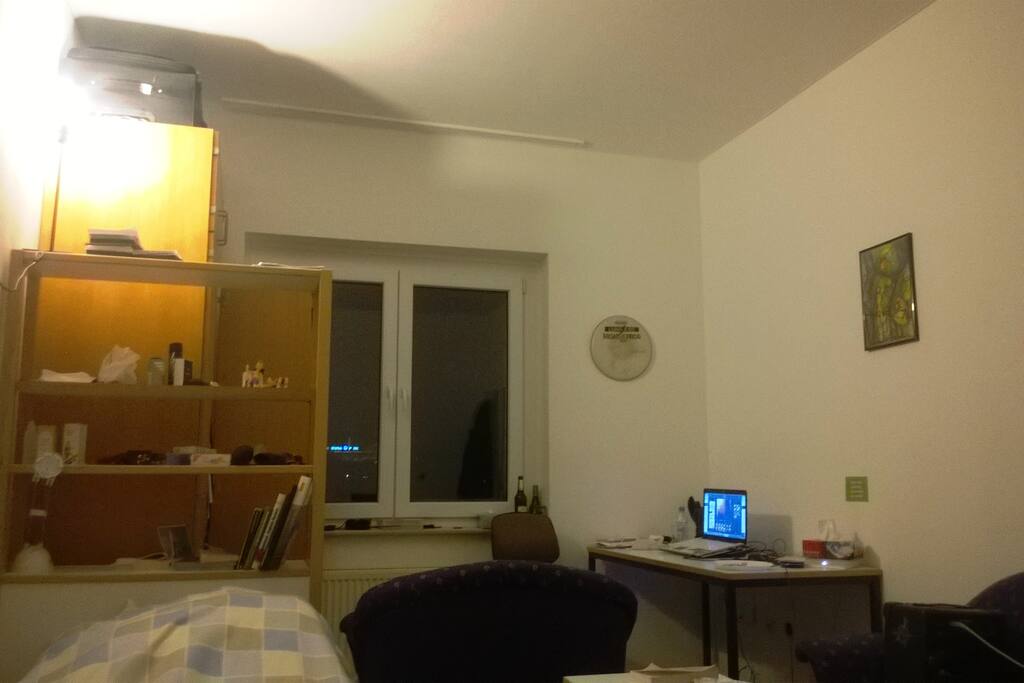 Shelves for books, large closet behind it. Working Desk and a large heater under the window. Always a warm room.