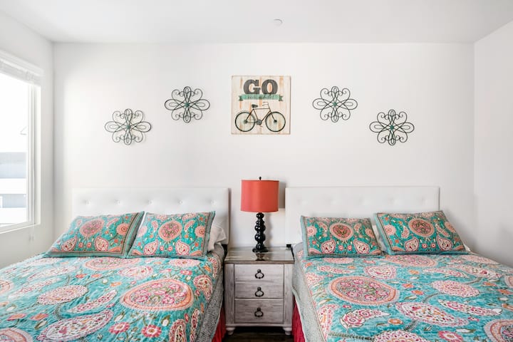 2nd Bedroom upstairs with 2 Queens, premium mattresses and full private bathroom.