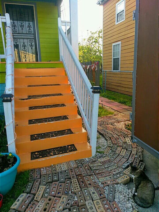 The path leads from the front of the house to the guest studio at the back.