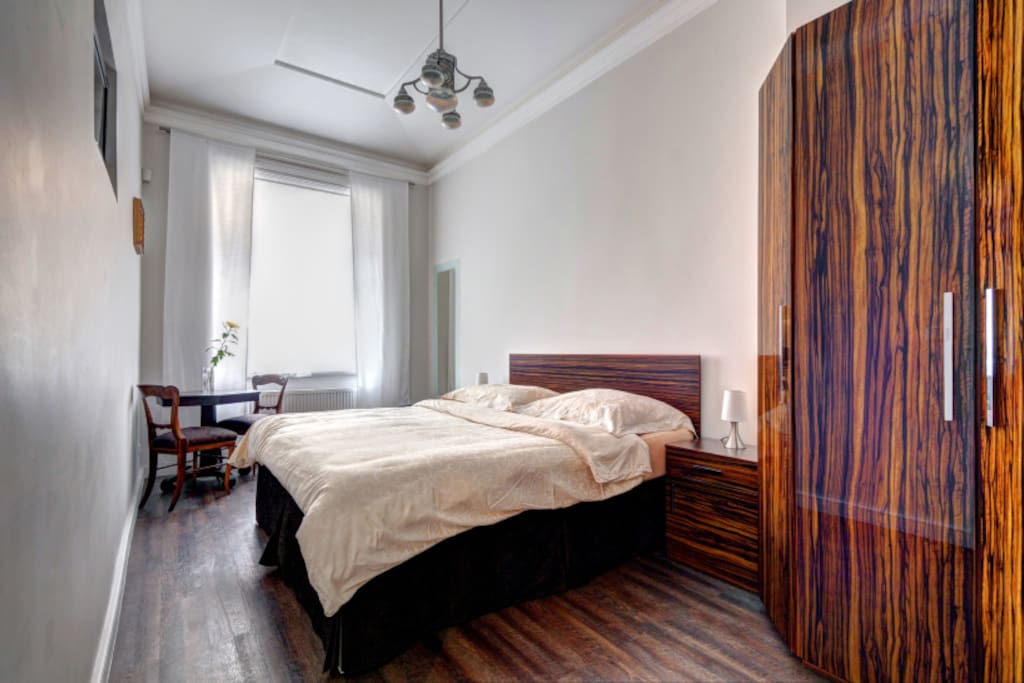 The bedroom with comfortable double bed and large wardrobe.
