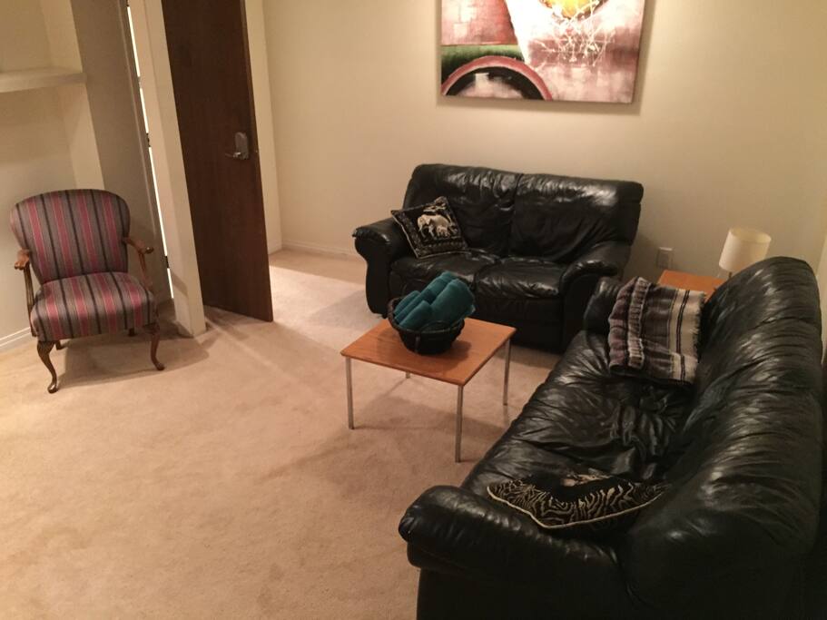 Living room area with leather couch and love seat