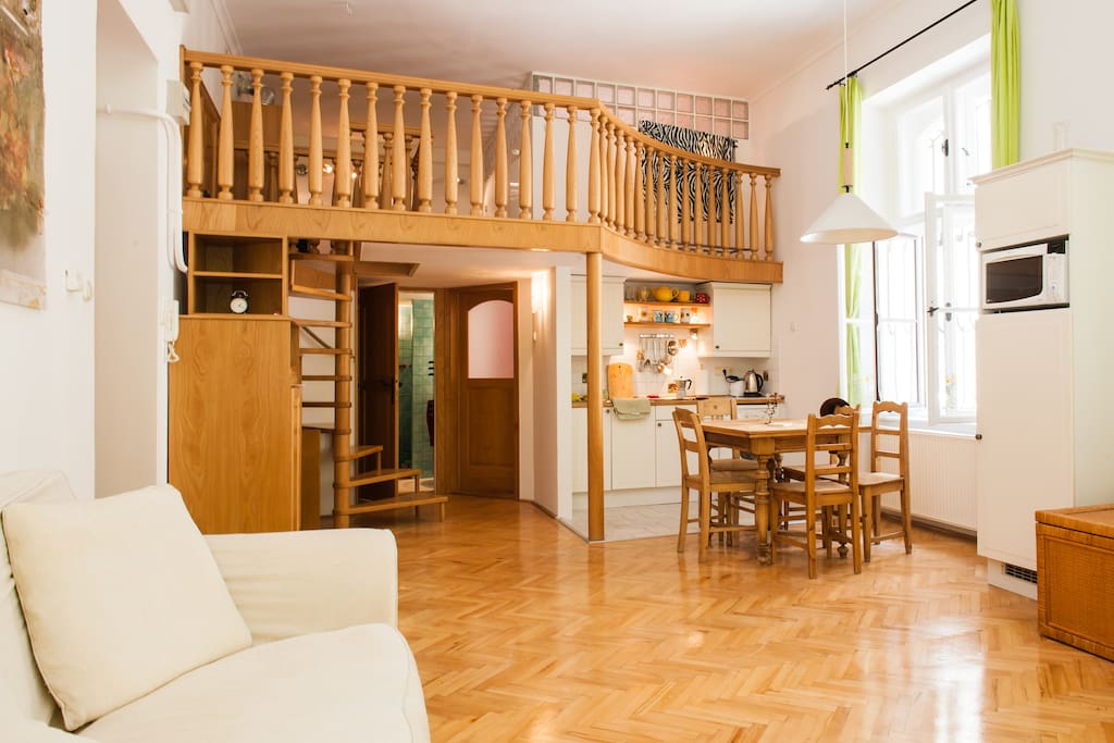 The sitting with mezzanine, high ceilings, full of light and 2 comfortable sofas one of which is a sofa bed
