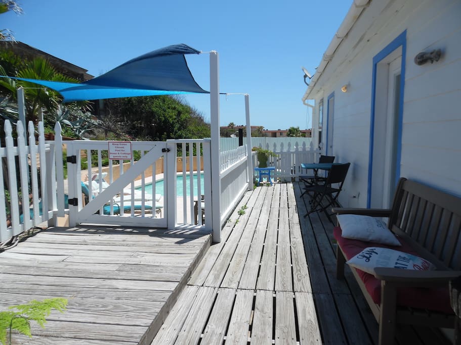 Entrance to the cottage with bistro seating overlooking the pool
