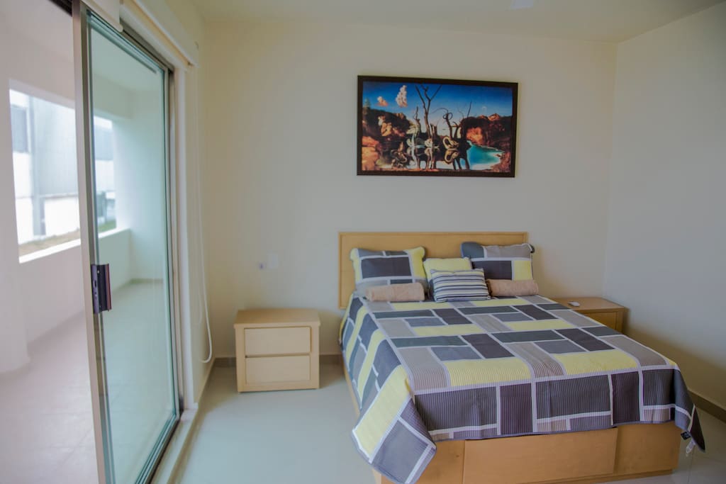 Queen size bed with Italian design. Entrance to the terrace.
