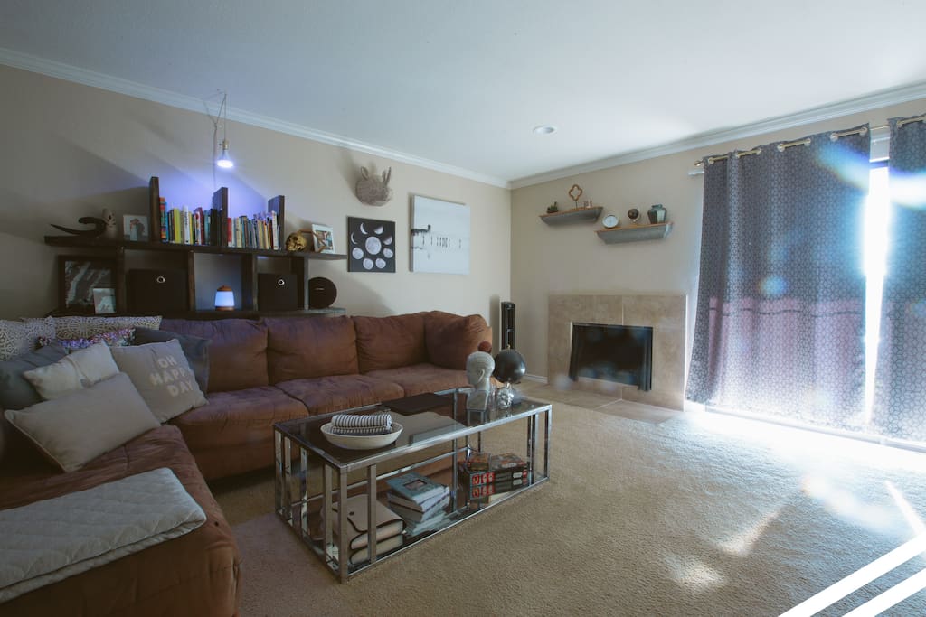 Living room with fireplace and access to patio. TV (not pictured) with cable TV available.