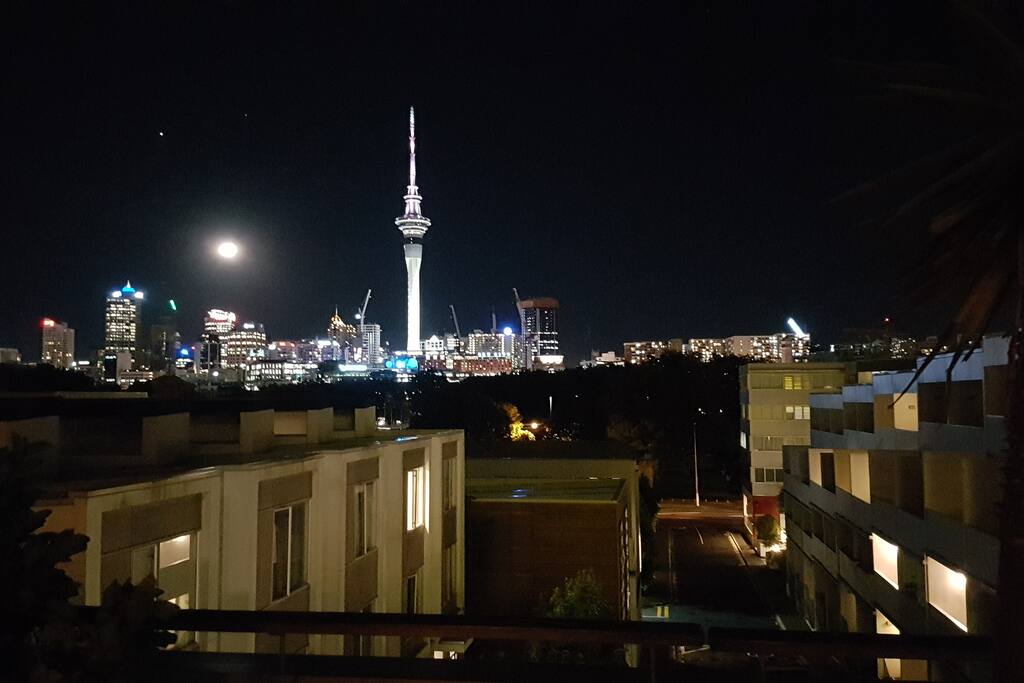 View of the city lights and Victoria Park from rooftop deck