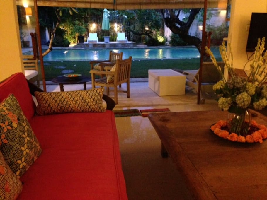 Sitting area with flat television overlooking the swimming pool.