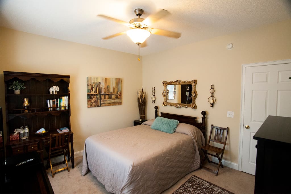 another view of bedroom showing chest of drawers and writing bureau