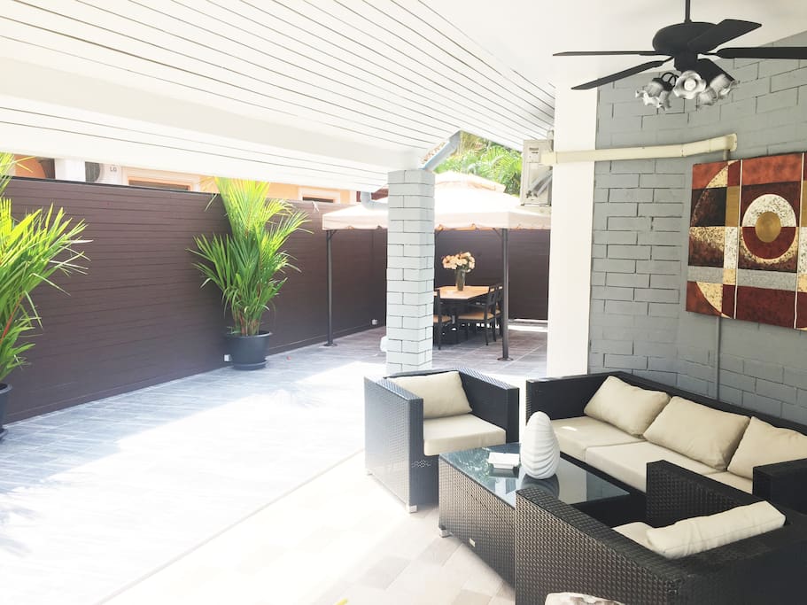 Outside sofa next to swimming pool