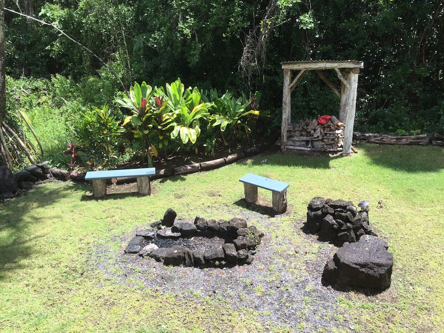 Back garden with fire pit and logs at the ready
