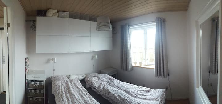 Here is space to push the beds to one side and put up a camping/crib that we have for free use .
The closet arrangement above the beds is opened from the bottom up and is available to the tenant. Next door there is hanger space to hang clothes.