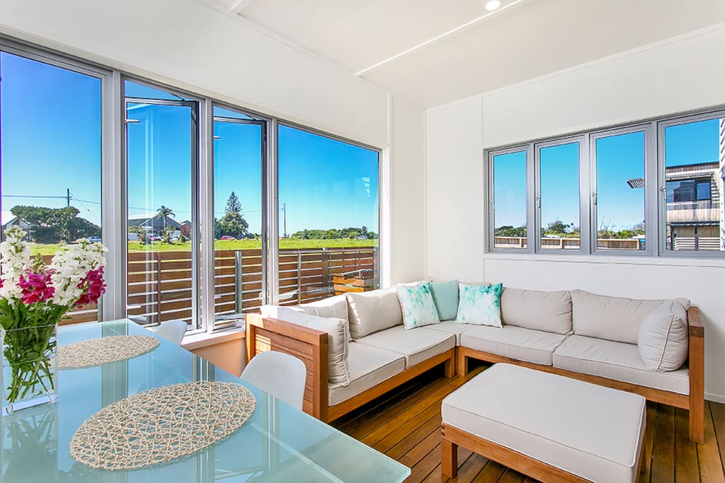 Sunny enclosed deck with views up to the lighthouse.