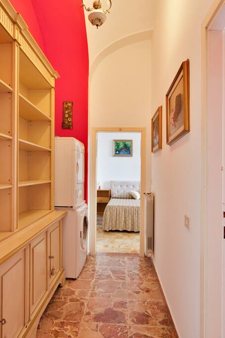 Hallway with plenty of storage and washer and dryer