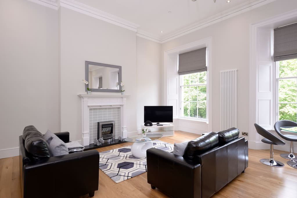 Comfortable Living Room with Leather Sofas and Dining Table